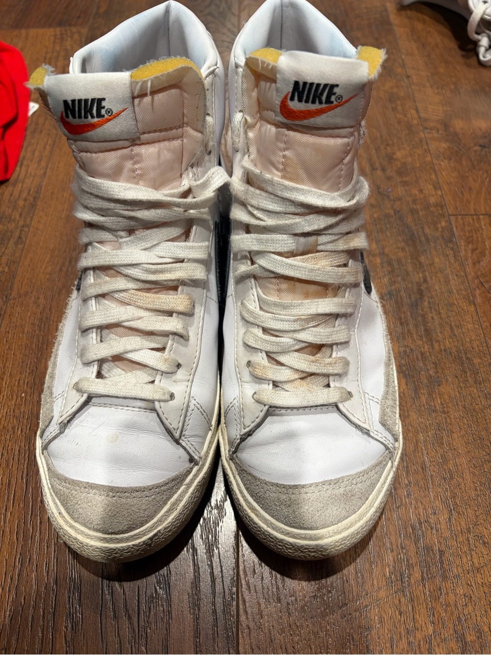 Nike White High-Top Sneakers with Orange Swoosh